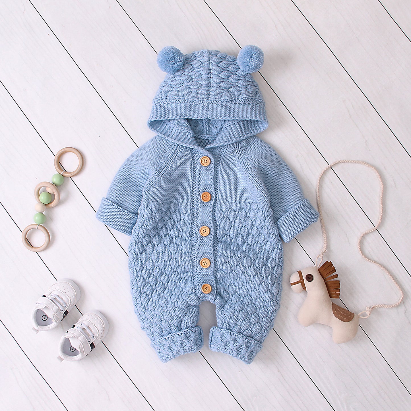 Côte & Crown blue knitted baby clothes with hood and pom-poms, wooden button details