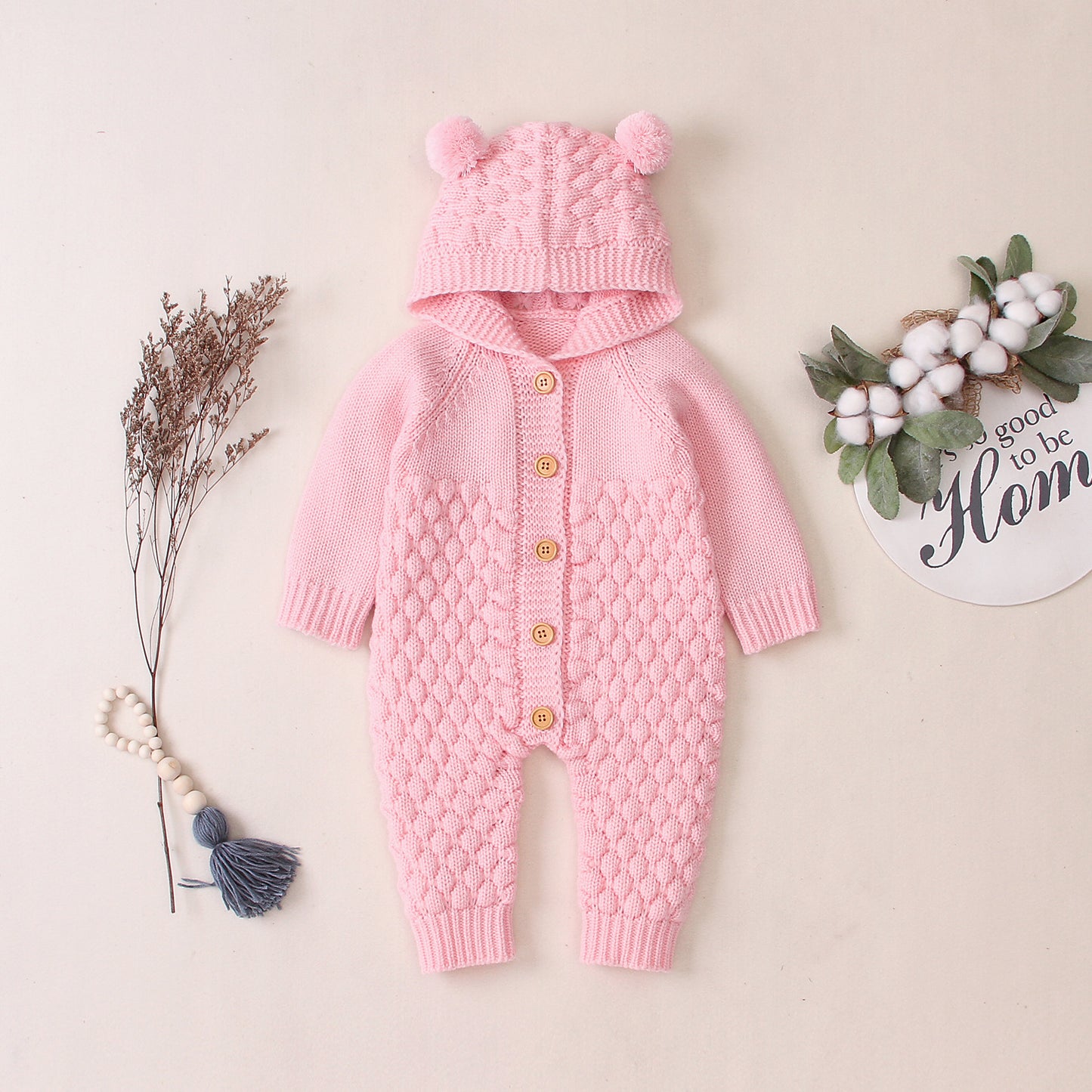 Côte & Crown pink knitted baby onesie with hood and pom pom ears buttons front design