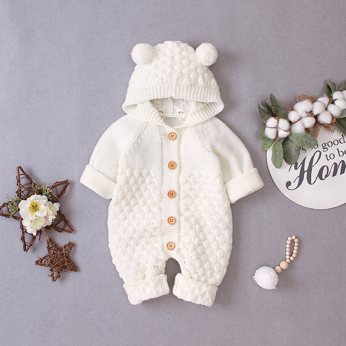 Côte & Crown white knitted baby clothes with hood and bear ears, featuring wooden buttons and textured pattern