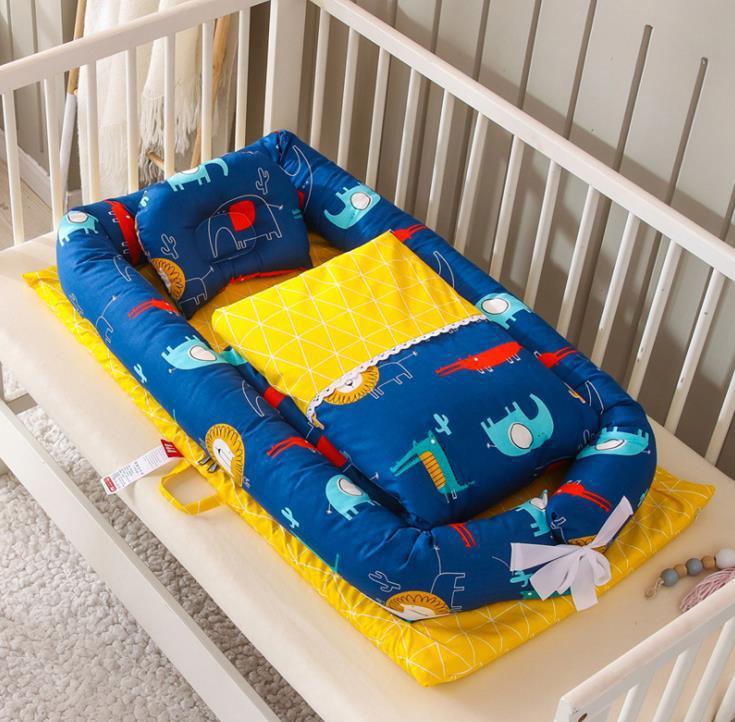 Côte & Crown foldable newborn middle baby bed with blue animal print and yellow cushion in white crib
