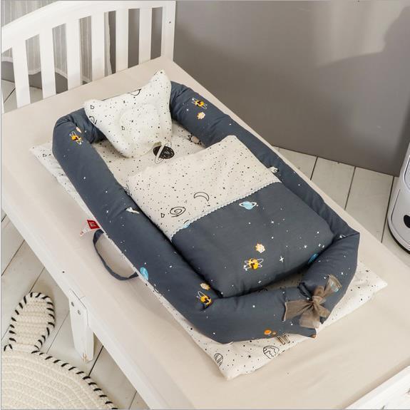 Côte & Crown newborn foldable middle bed baby infant with dark space-themed bedding on white crib