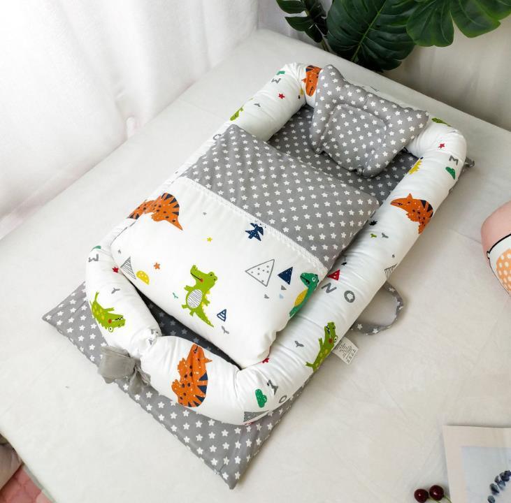 Côte & Crown foldable newborn middle bed with grey star pattern and colorful dinosaur print