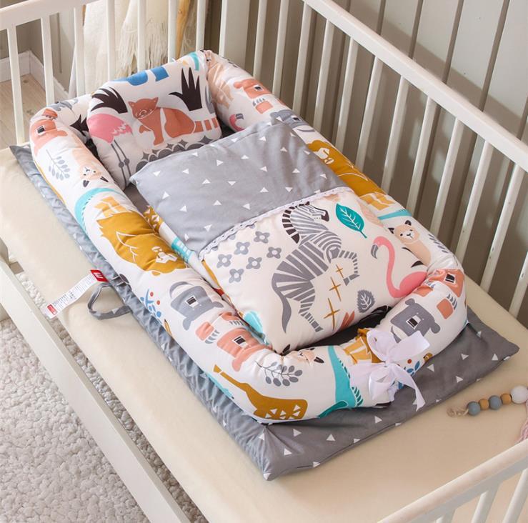 Côte & Crown foldable new-born middle bed baby infant with colorful animal prints in a white crib