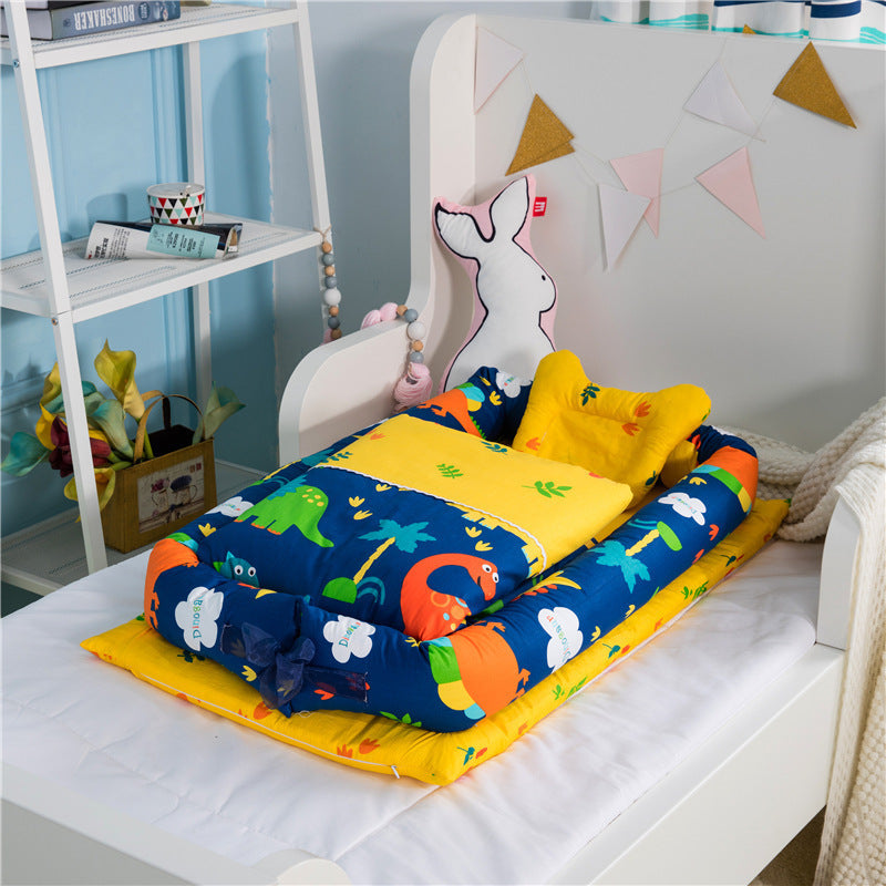 Côte & Crown foldable middle bed for newborns with colorful dinosaur print and soft yellow cushion