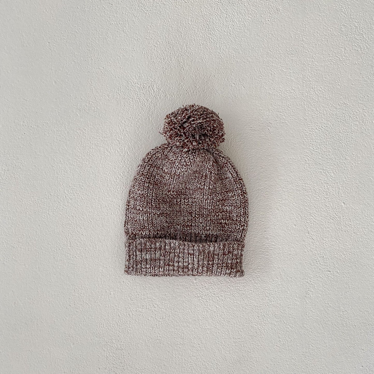Côte & Crown soft knitted baby hat with pom pom in brown and white yarn