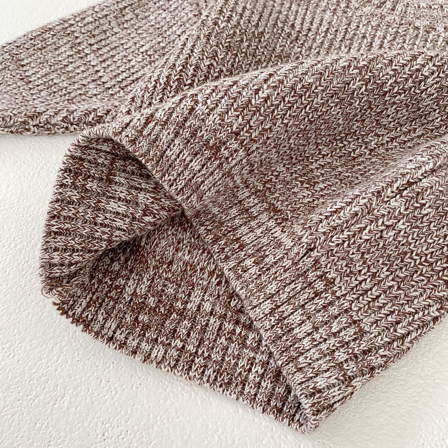 Close-up of soft knit fabric in brown and cream for Côte & Crown baby clothes