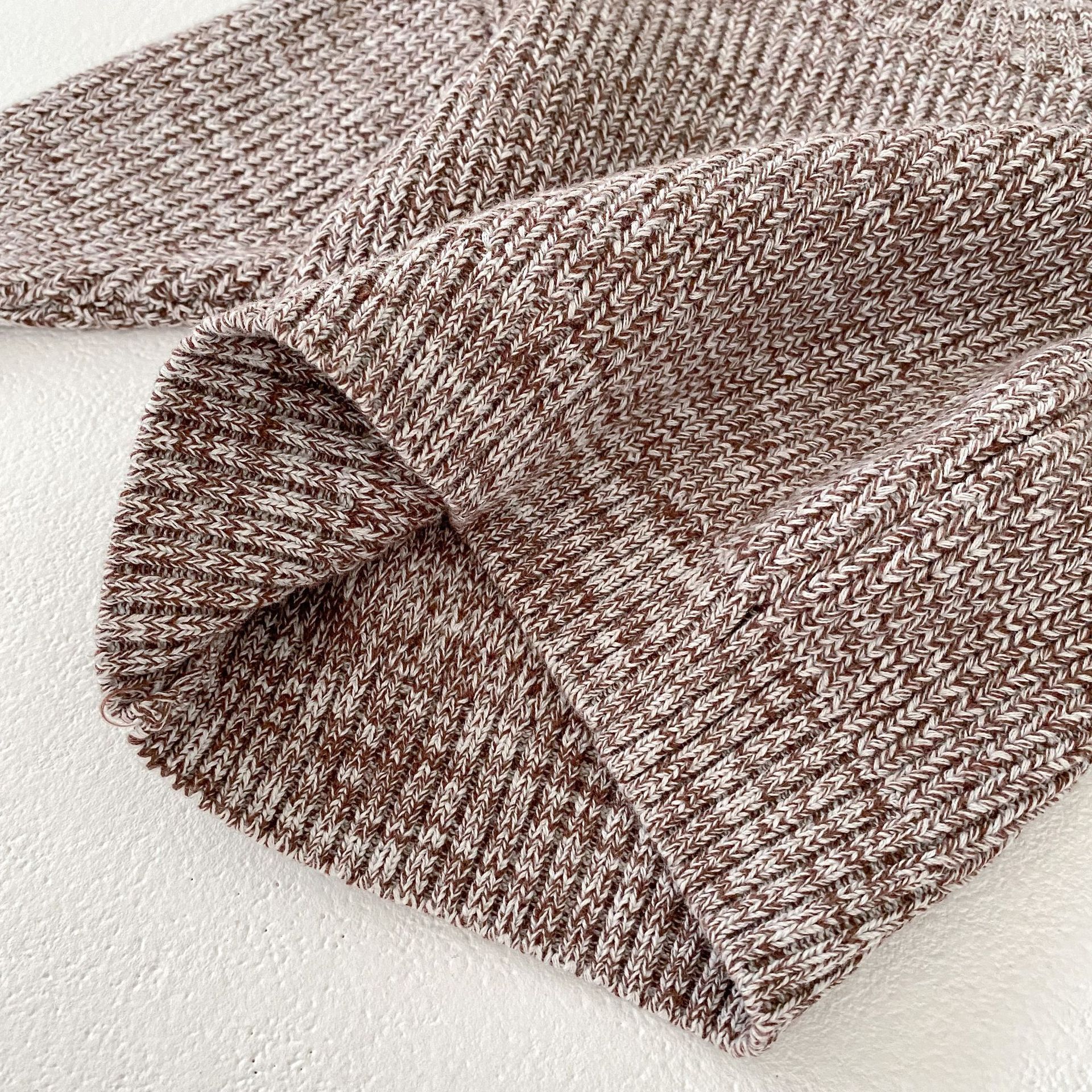 Close-up of soft knit fabric in brown and cream for Côte & Crown baby clothes