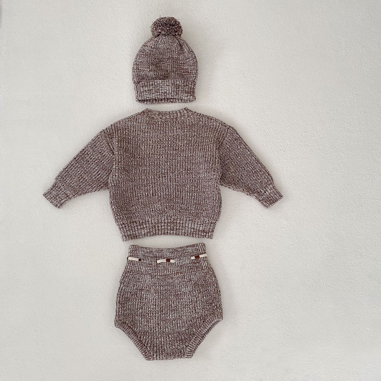 Côte & Crown three-piece knitted baby clothes set with sweater hat and diaper cover in soft brown yarn
