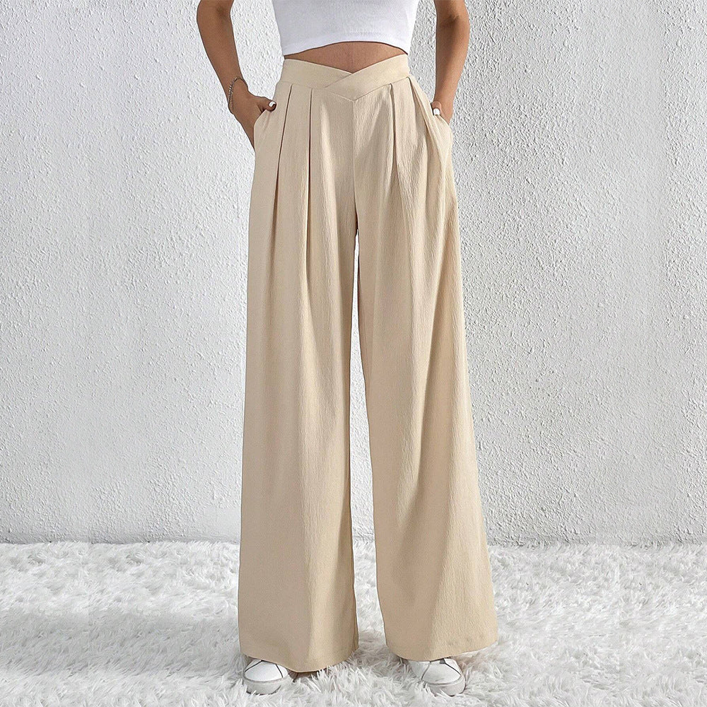 Côte & Crown womens beige wide-leg trousers with pleats and pockets styled with a white crop top