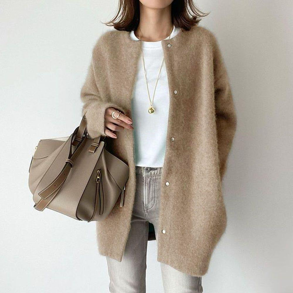 Hauteloom beige cardigan featuring button closure, worn over a white top and grey jeans