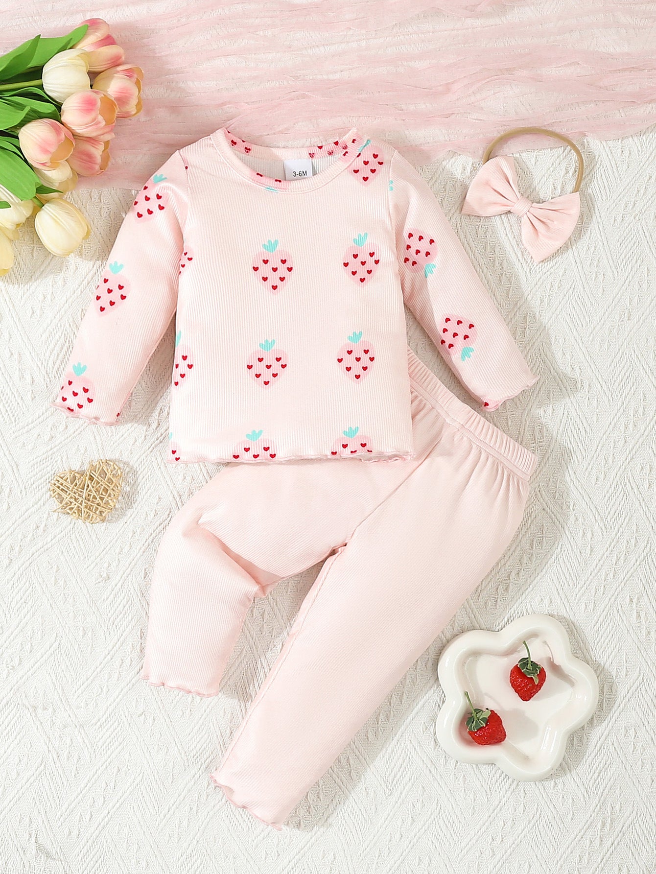 Infant printed 3 piece outfit by Côte & Crown featuring a pink strawberry print top, matching pants, and a bow headband