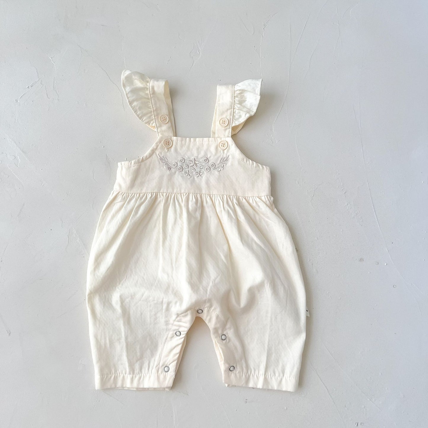 Côte & Crown luxury baby girl outfit affordable cream loose adjustable suspender romper