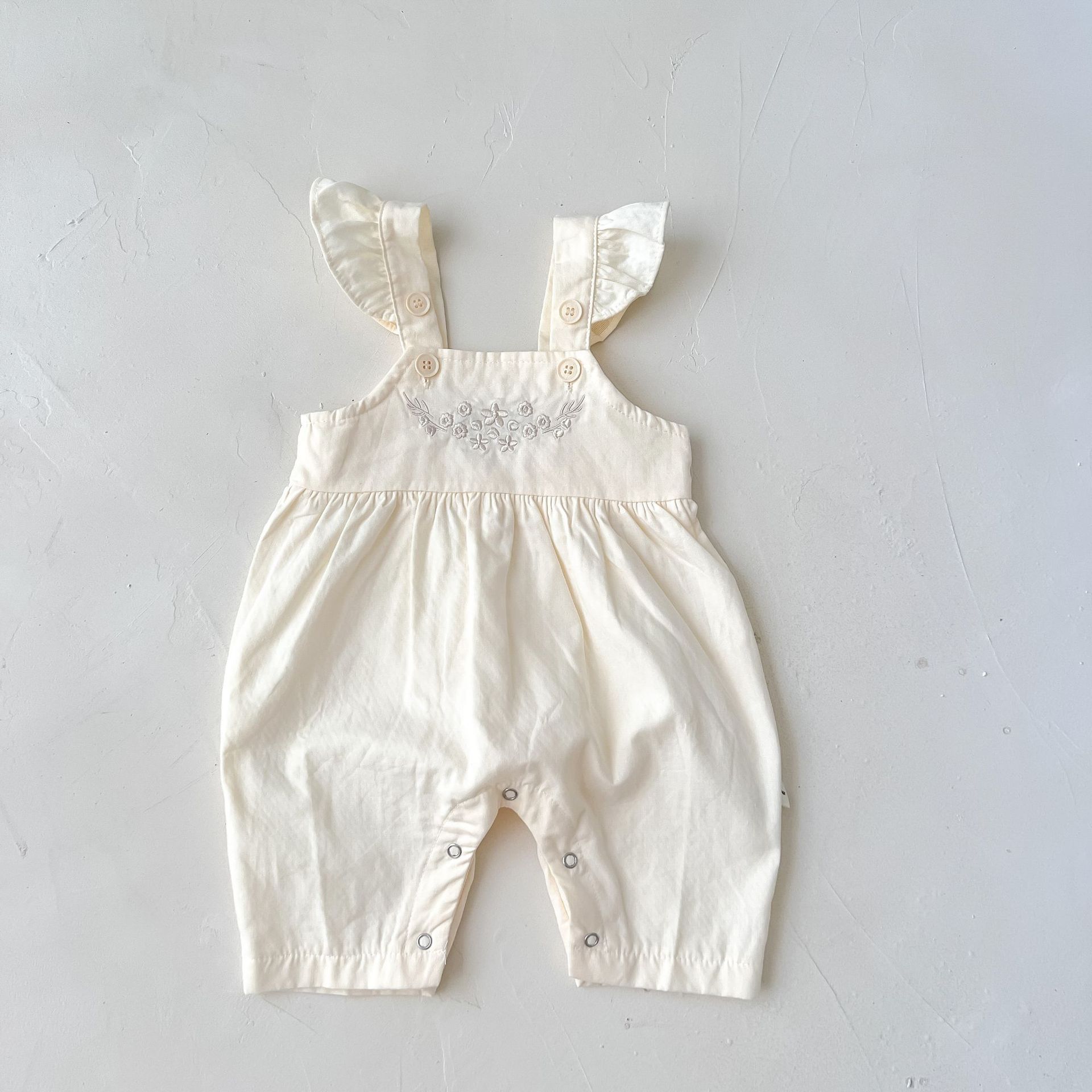 Côte & Crown luxury baby girl outfit affordable cream loose adjustable suspender romper