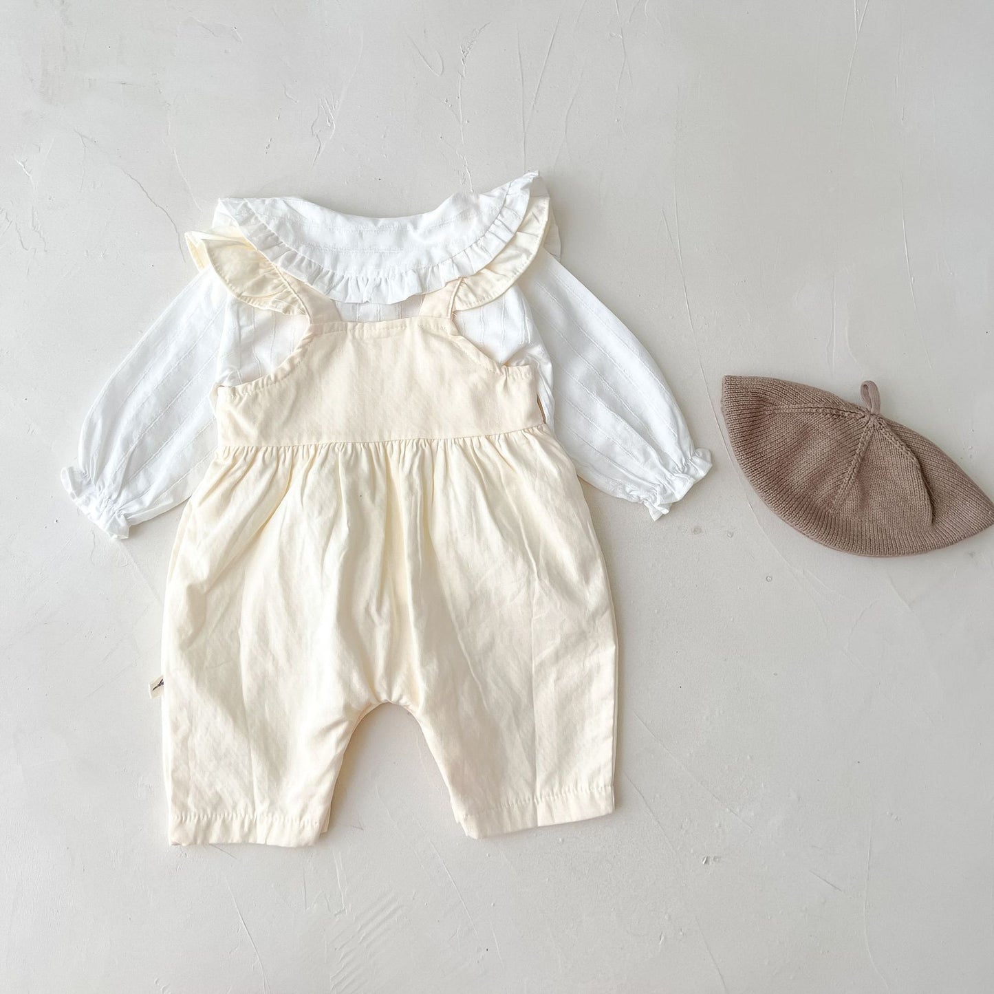 Luxury baby girl outfit affordable with Côte & Crown cream adjustable suspender romper and white ruffled blouse