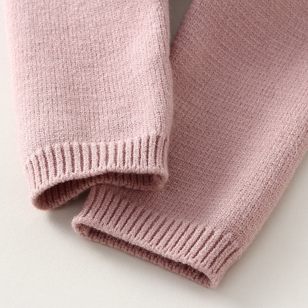Close-up of pink children's knitted sweater set cuffs showing soft knit texture