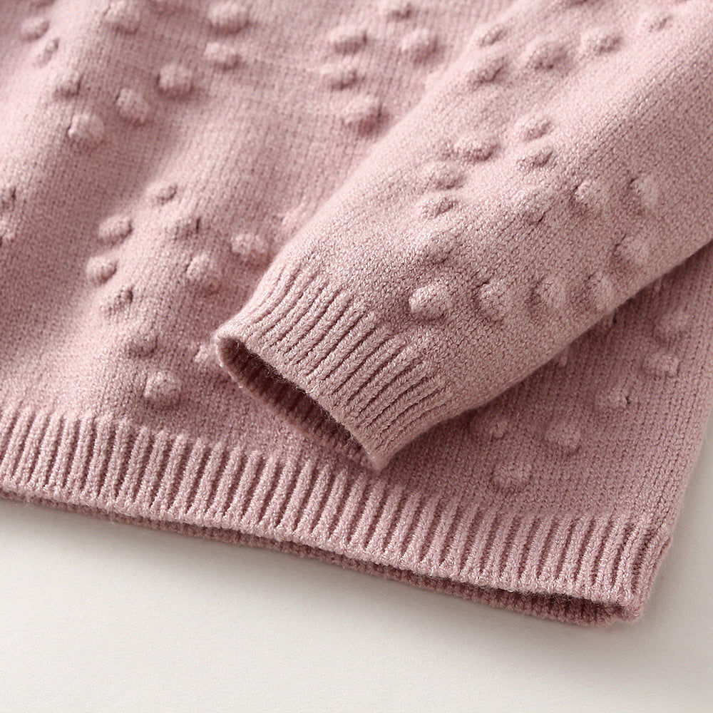Pink children's knitted sweater set with textured dot pattern and ribbed cuffs by Côte & Crown