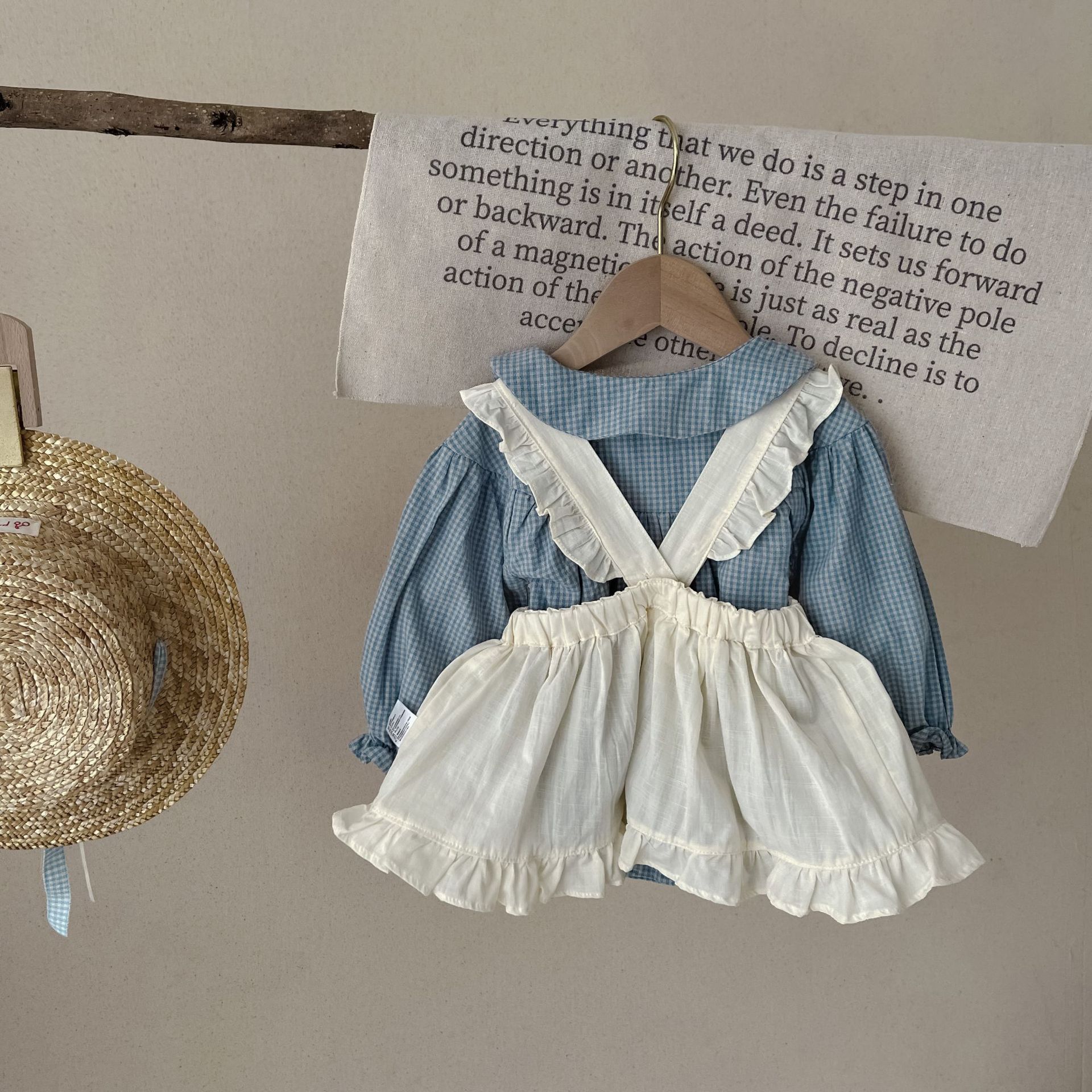 Côte & Crown ruffled baby romper dress in blue with white ruffled overlay and long sleeves
