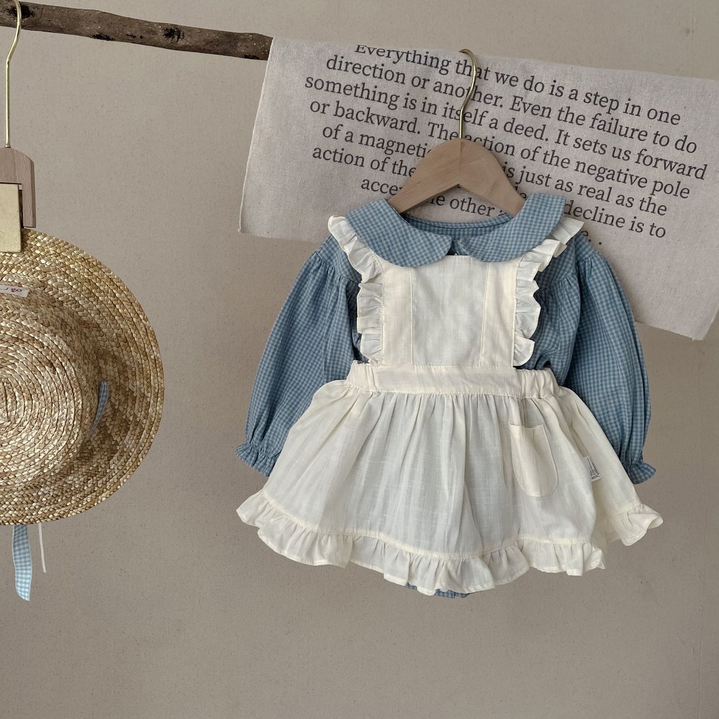 Côte & Crown ruffled baby romper dress in blue and white with long sleeves and frilled edges