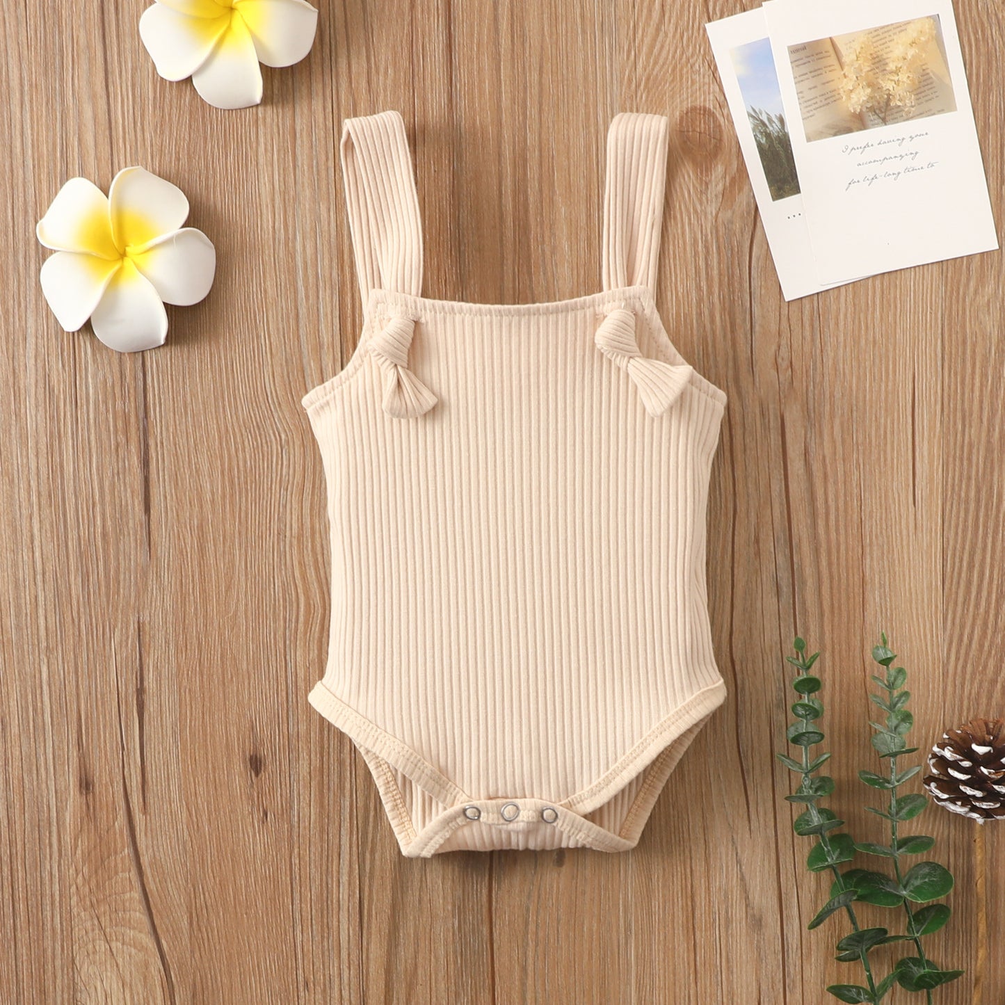 Beige Côte & Crown baby strap small romper made from soft cotton romper for babies with ribbed texture