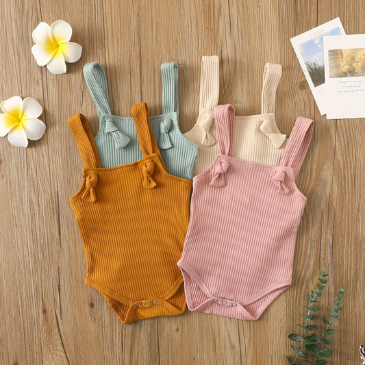 Côte & Crown soft cotton romper for babies in ribbed fabric with small strap design in pastel pink, mustard, beige, and blue