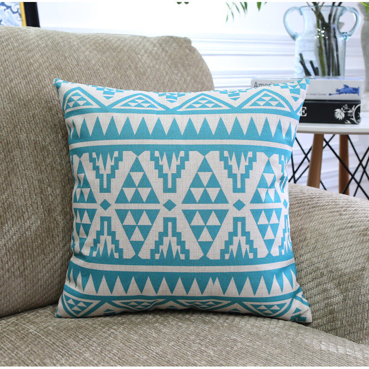 Côte & Crown soft furnishing decorative cushion with blue geometric pattern on a beige sofa