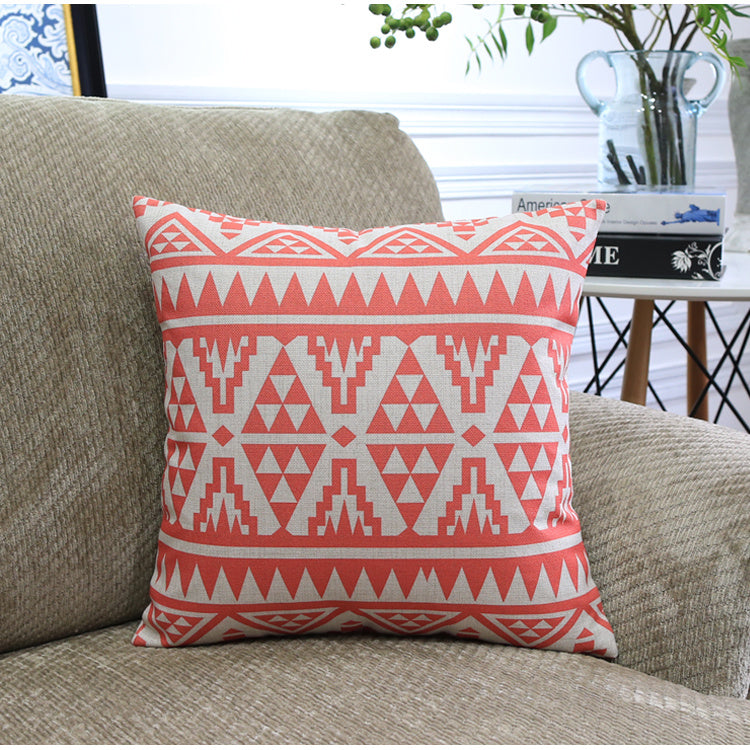 Côte & Crown soft furnishing decorative cushion with red geometric pattern on beige sofa