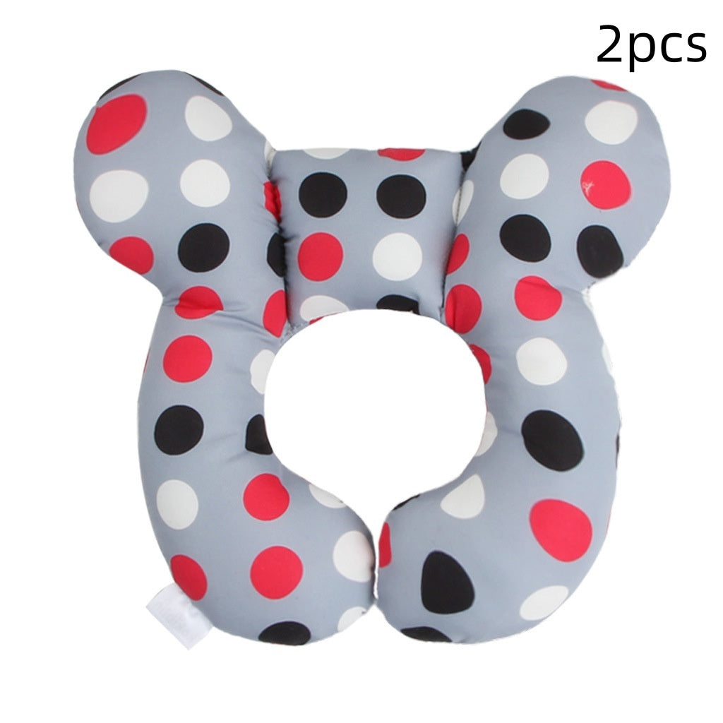Côte & Crown U-shaped neck guard pillow for stroller with red black and white polka dots