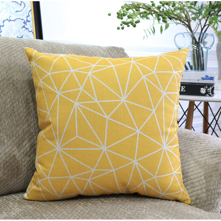 Côte & Crown yellow geometric patterned soft furnishing cushion on beige sofa