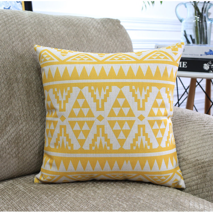 Côte & Crown yellow and white geometric patterned soft furnishing cushion on beige sofa